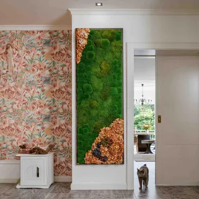 Detailed preserved moss composition in warm green and copper tones within a classic interior