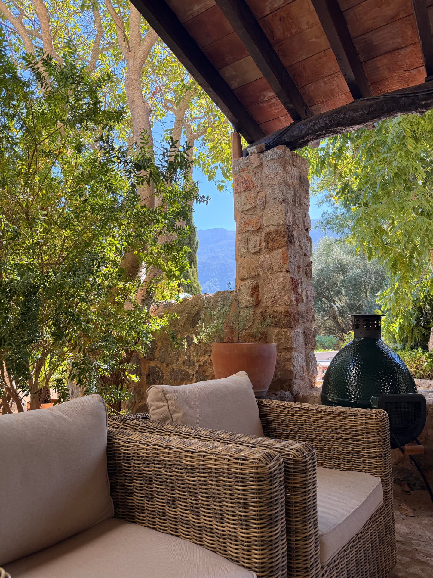 Covered stone terrace of a traditional Mallorcan finca with Tramuntana mountain views