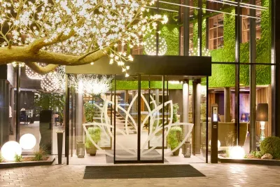 Hotel entrance at night with a preserved moss façade — a MOOSMOOS installation from the company chronicle